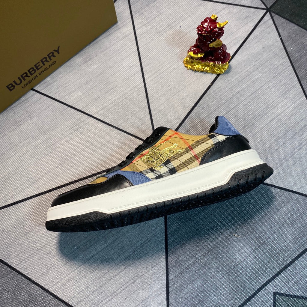 Burberry low-top sneaker side view with plaid upper, gold graphic, white sole, black outsole edge