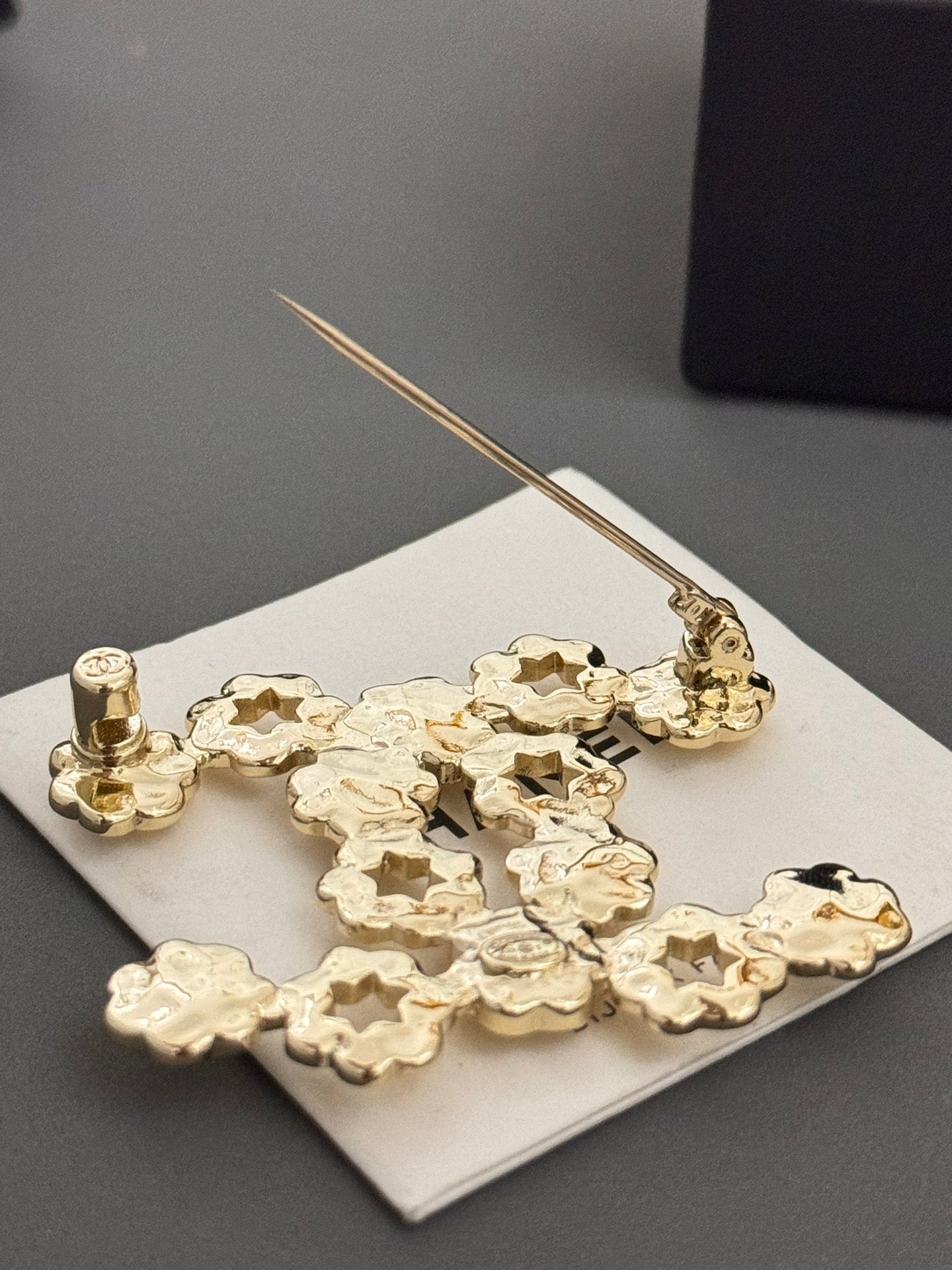 Chanel gold-tone statement brooch pin with floral charms and needle detail
