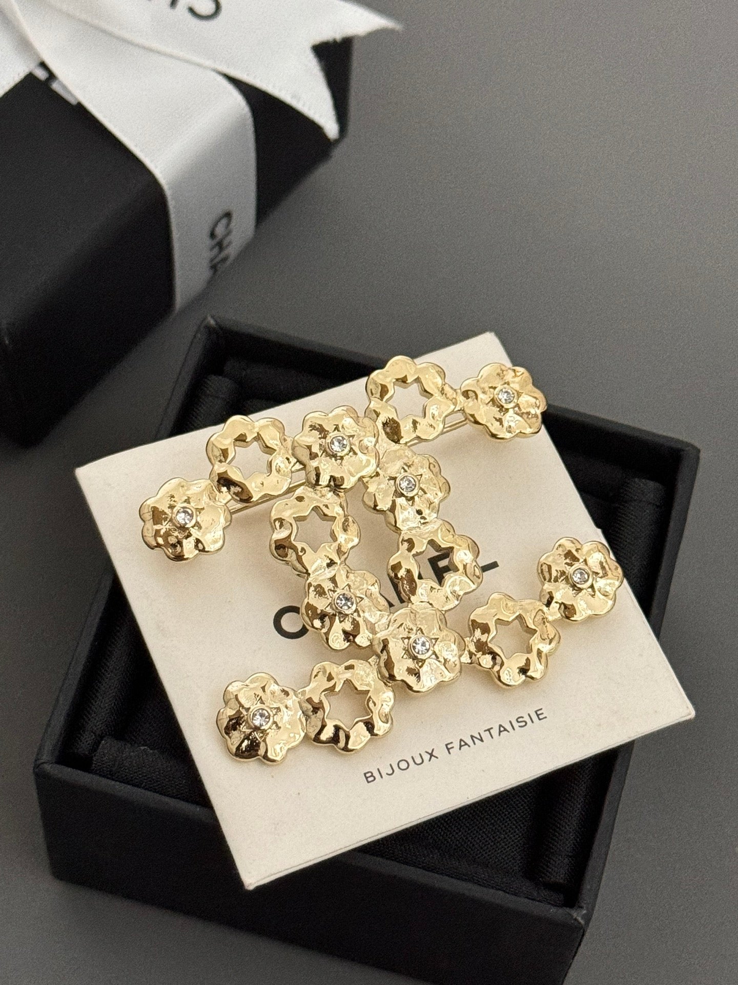 Chanel gold-tone statement brooch with floral charms on card in gift box