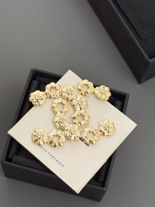 Chanel gold-tone statement brooch with floral quatrefoil charms on card