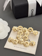 Chanel gold-tone statement brooch with floral charms on card, gift box shown