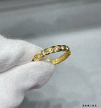 Gold-toned oval pavé ring on finger