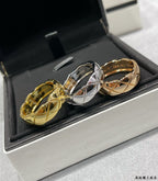 Pair of textured band rings, one gold tone and one silver tone, in a box