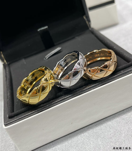 Pair of textured band rings, one gold tone and one silver tone, in a box