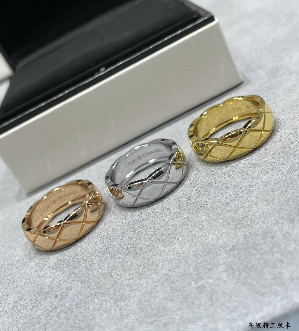 Two band rings, gold tone and silver tone, shown on gray fabric