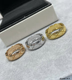 Two band rings, gold tone and silver tone, shown on gray fabric