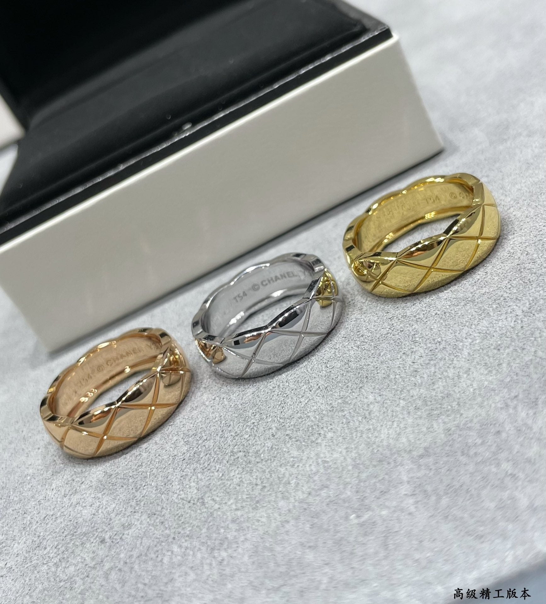Two band rings, gold tone and silver tone, shown on gray fabric