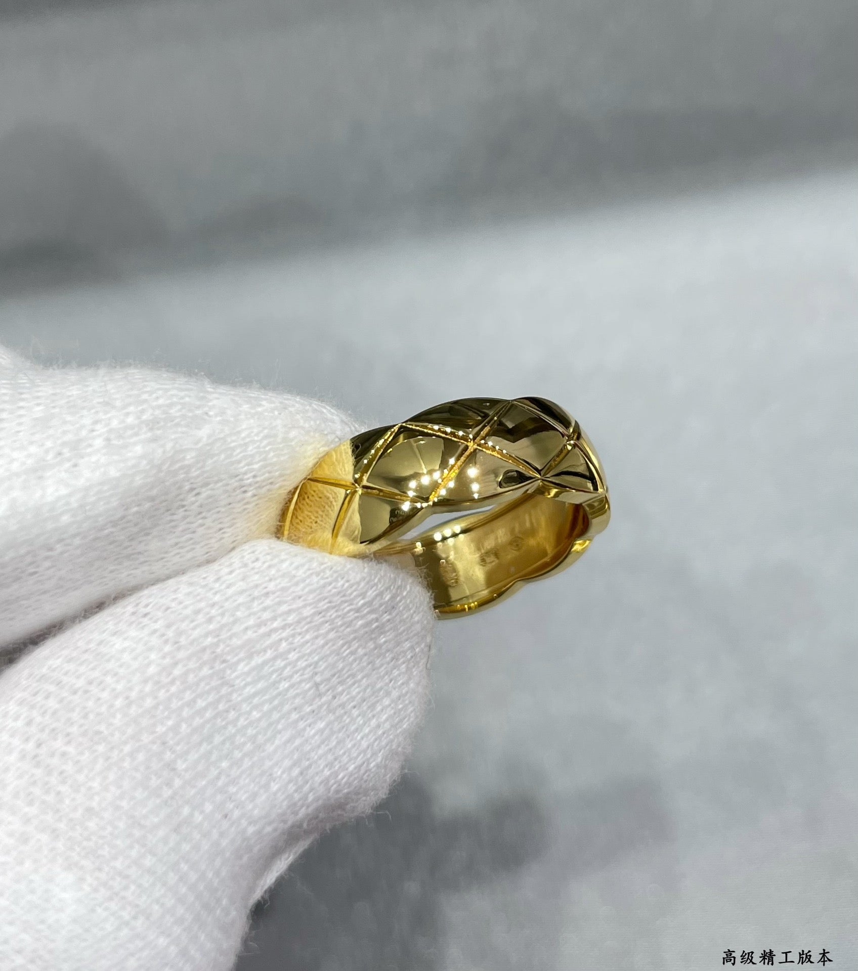 Gold tone faceted band ring with diamond-like woven texture
