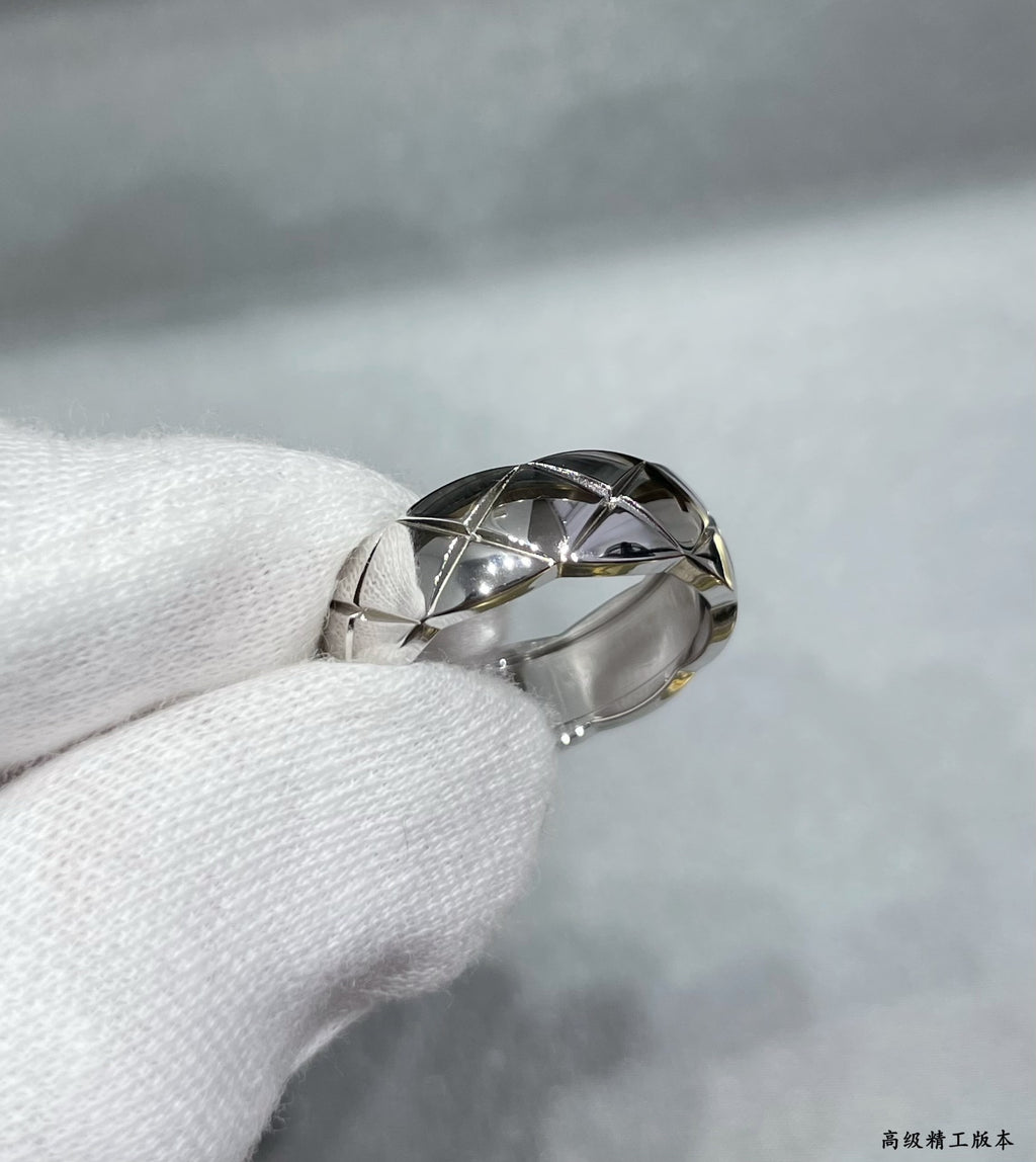 Silver tone textured band ring with faceted geometric pattern