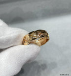Gold tone textured band ring with faceted geometric pattern