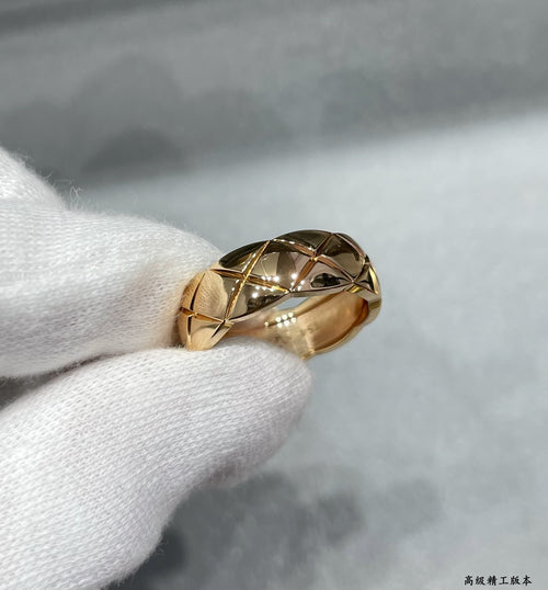 Gold tone textured band ring with faceted geometric pattern
