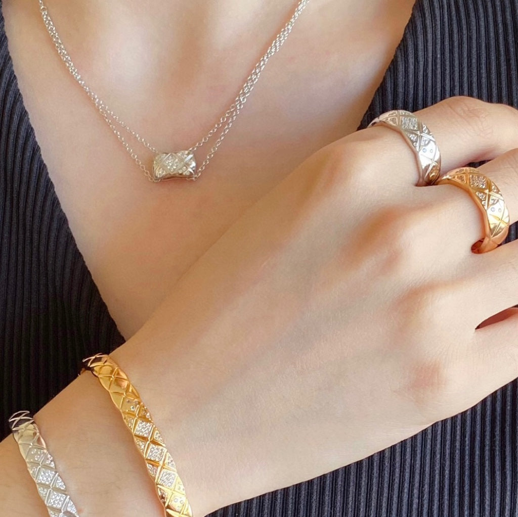 Chanel accessories: gold-tone bracelet and ring with pavé stones on hand