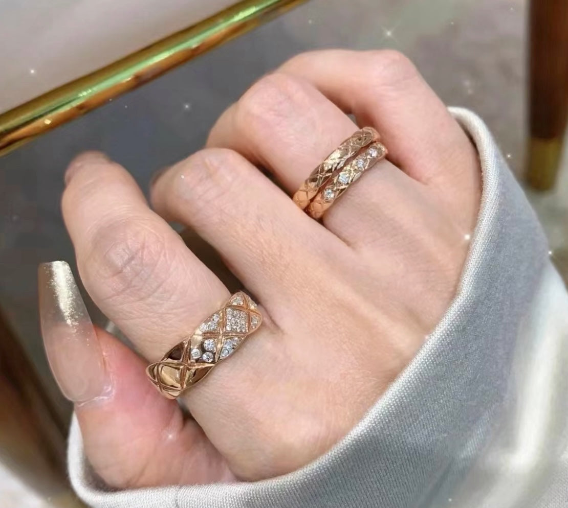 Chanel accessories: gold-tone rings with pavé stone bands on hands
