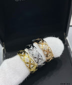Chanel accessories: two rings in gold and silver-tone with pavé stone detail