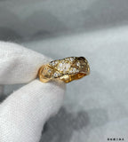 Chanel accessories: gold ring with crisscross pavé stones on finger