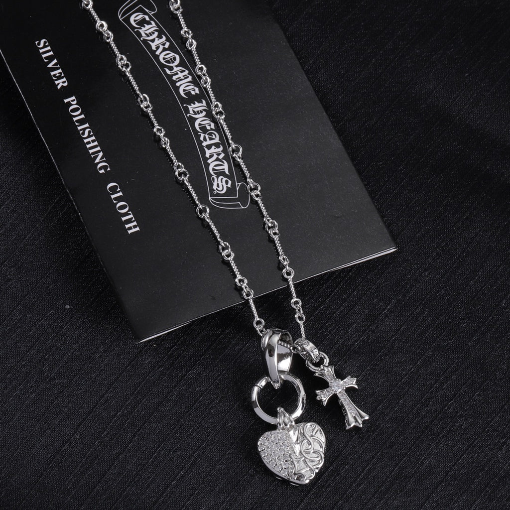 Heart and cross pendant necklace with linked chain, silver tone