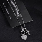 Heart and cross pendant necklace with linked chain, silver tone
