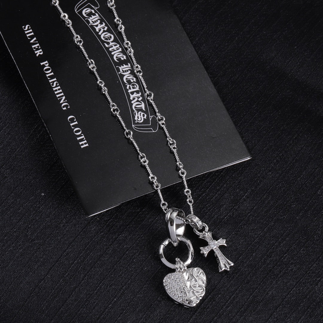 Heart and cross pendant necklace with linked chain, silver tone