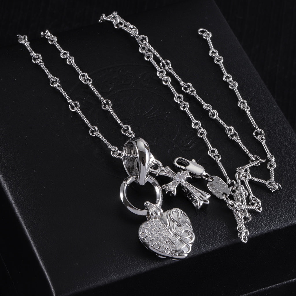Heart locket and cross pendant necklace on chain, silver tone