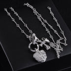 Heart locket and cross pendant necklace on chain, silver tone