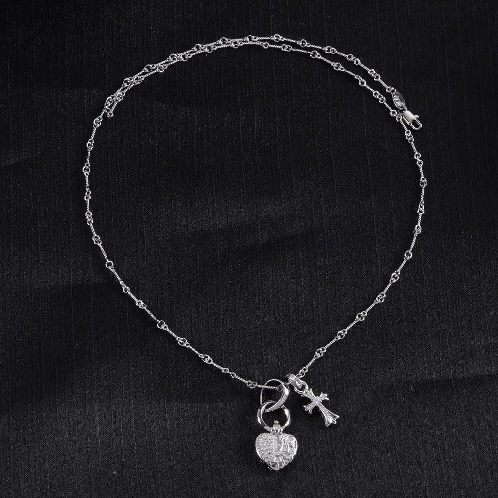 Single heart locket and cross pendant necklace with linked chain, silver tone