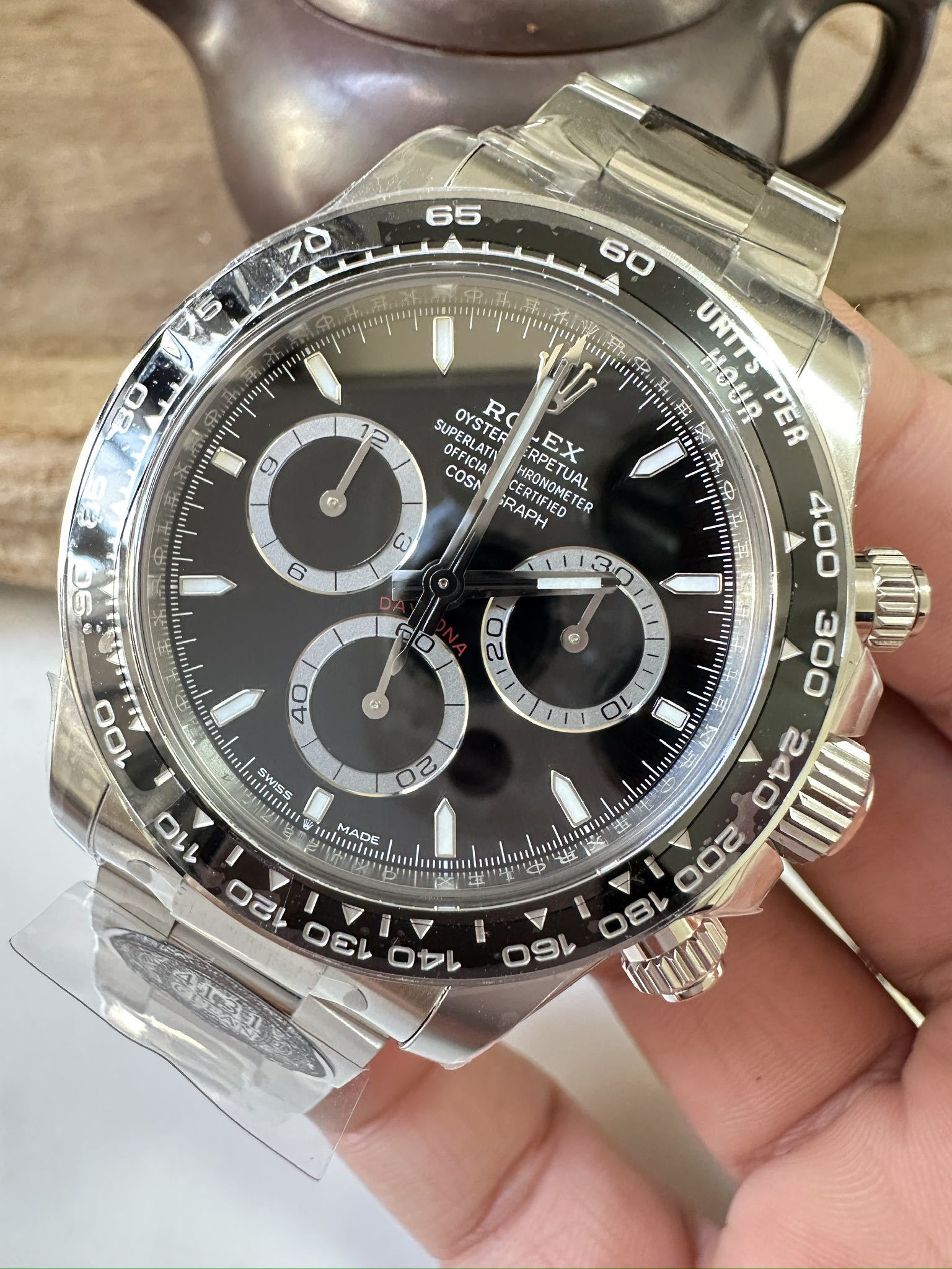 Steel chronograph watch with dark dial, three subdials and gold-tone bezel accents