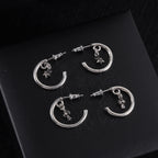 Silver hoop earrings with star charm and stud backing, circular silhouette
