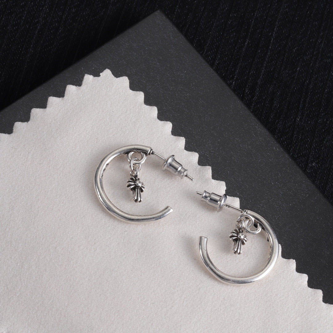 Silver hoop earrings with star charms and back posts on light card