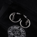 Silver hoop earring with star charm and post stud, close front view