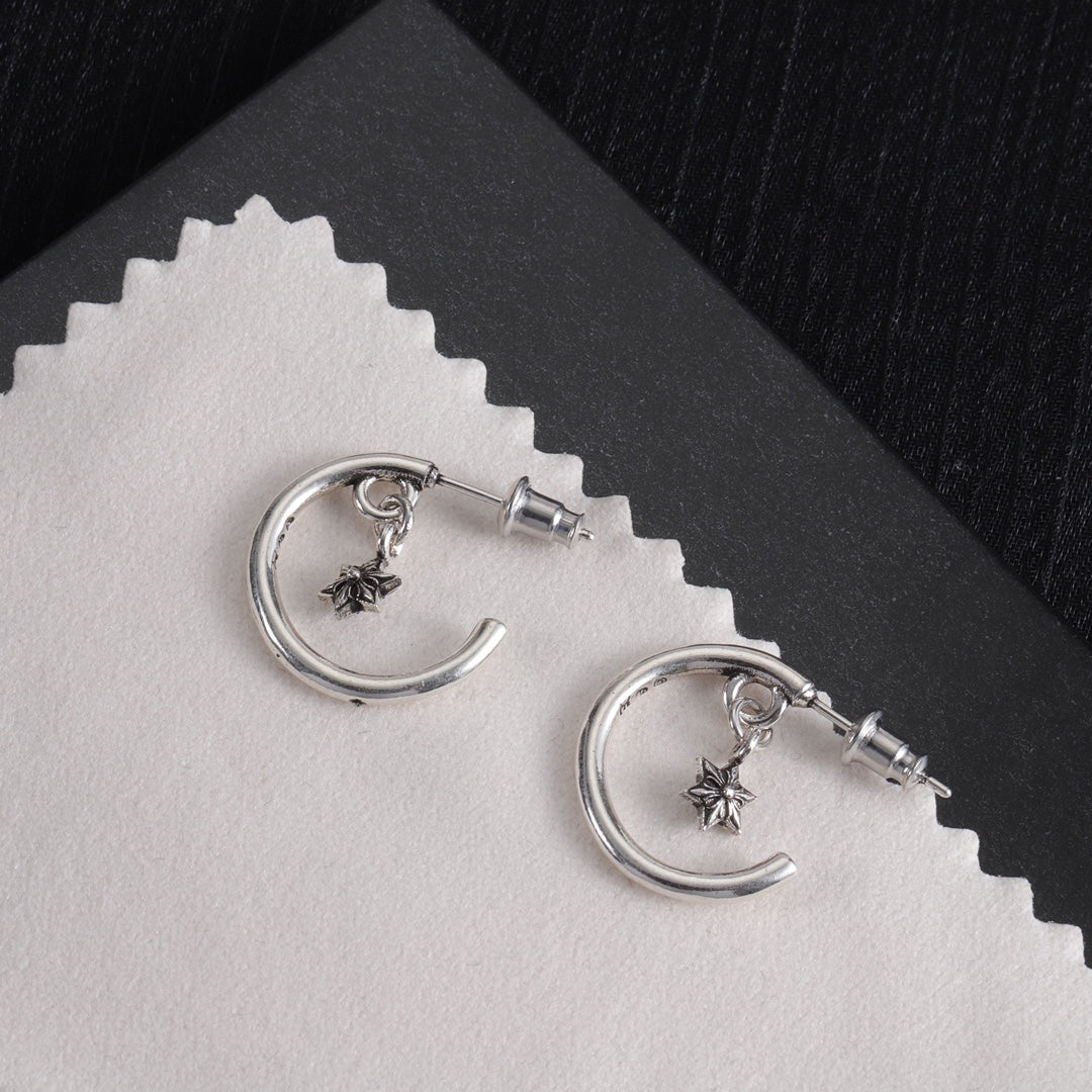 Silver hoop earrings with star charms and back posts, closeangled view