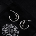 Silver hoop earrings with star charms and post studs, angled pair