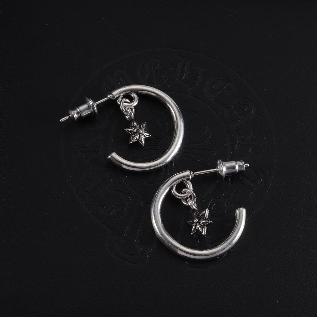Pair of silver hoop earrings with star charms and post studs, top view