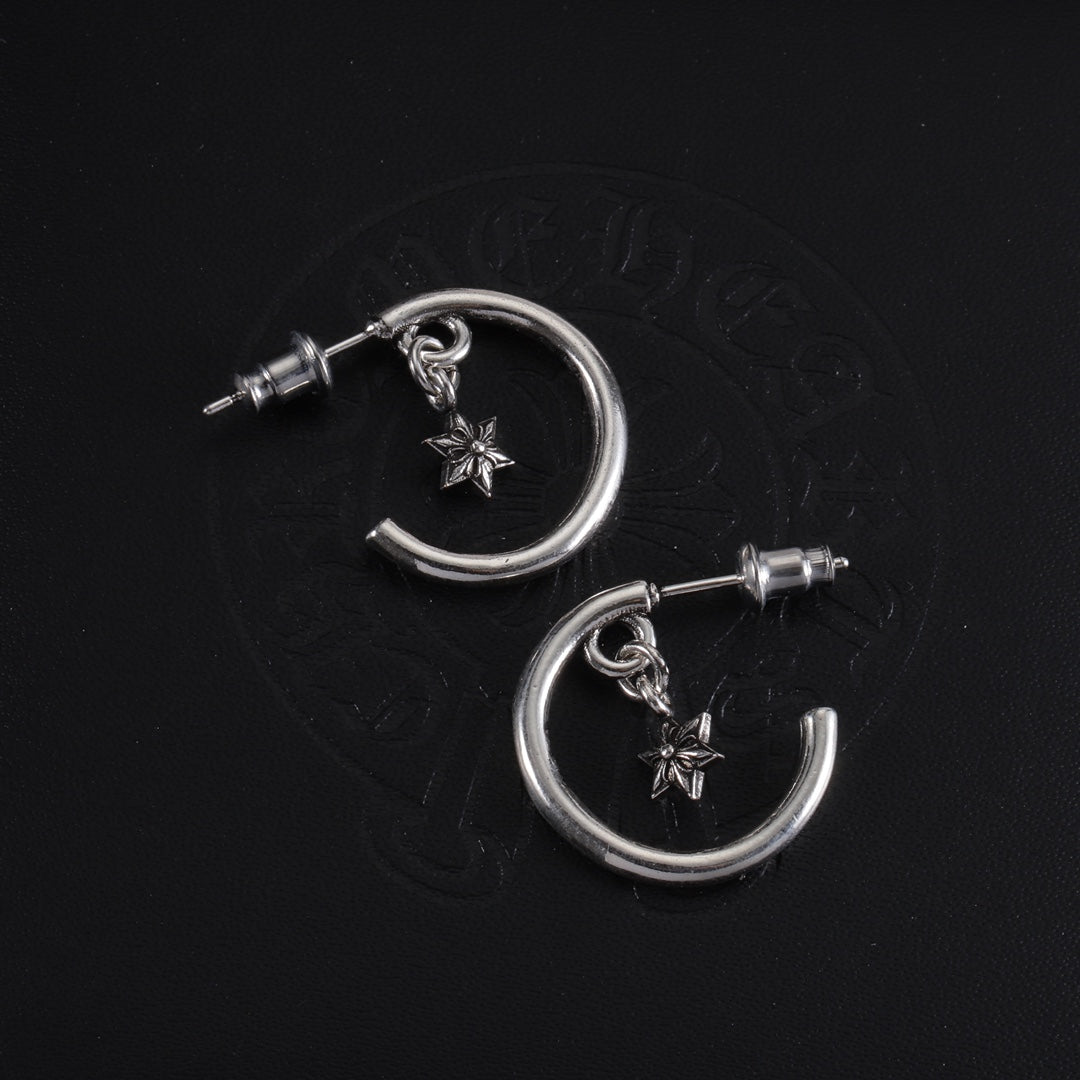 Pair of silver hoop earrings with star charms and post studs, top view