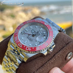 Rolex GMT-Master watch close-up, steel case, light dial, pink-red bezel, markers