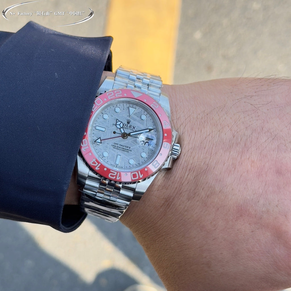 Rolex GMT-Master watch on wrist, steel bracelet, light dial, pink-red bezel