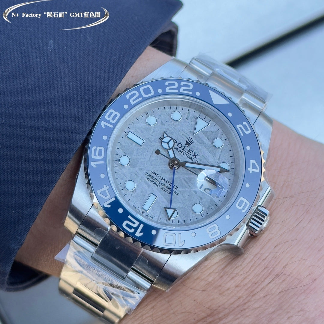 Rolex GMT-style watch with blue bezel and textured dial, steel bracelet on wrist