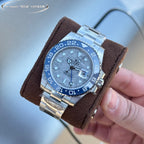 Rolex GMT-style watch with blue bezel and dial, steel bracelet on brown cushion strap