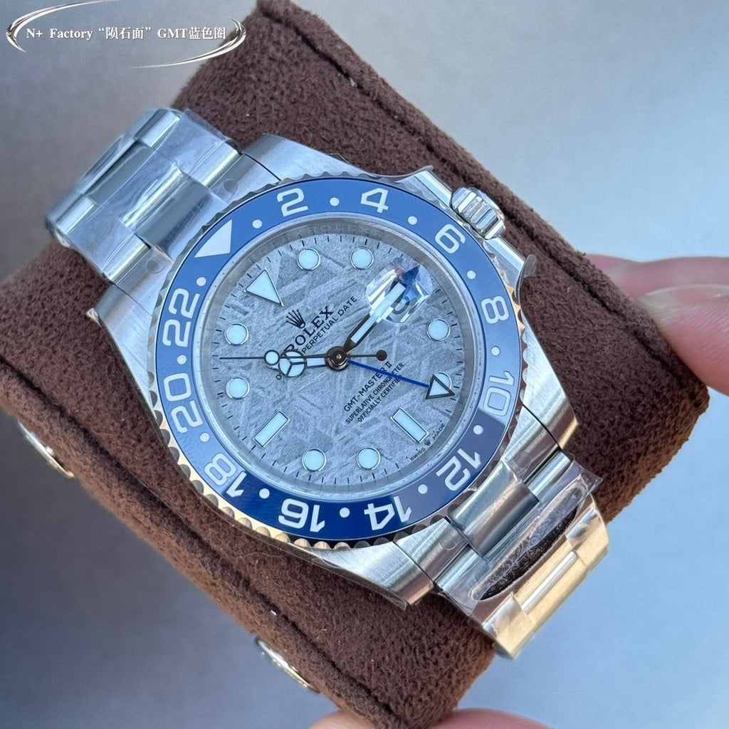 Rolex GMT-Master II style watch with blue bezel and dial, steel bracelet, on brown strap