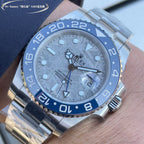 Rolex GMT-style watch close-up with blue bezel and dial, stainless steel bracelet