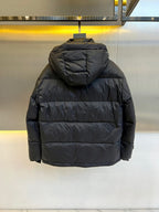 Dark hooded puffer jacket back view with horizontal quilting and logo hood trim