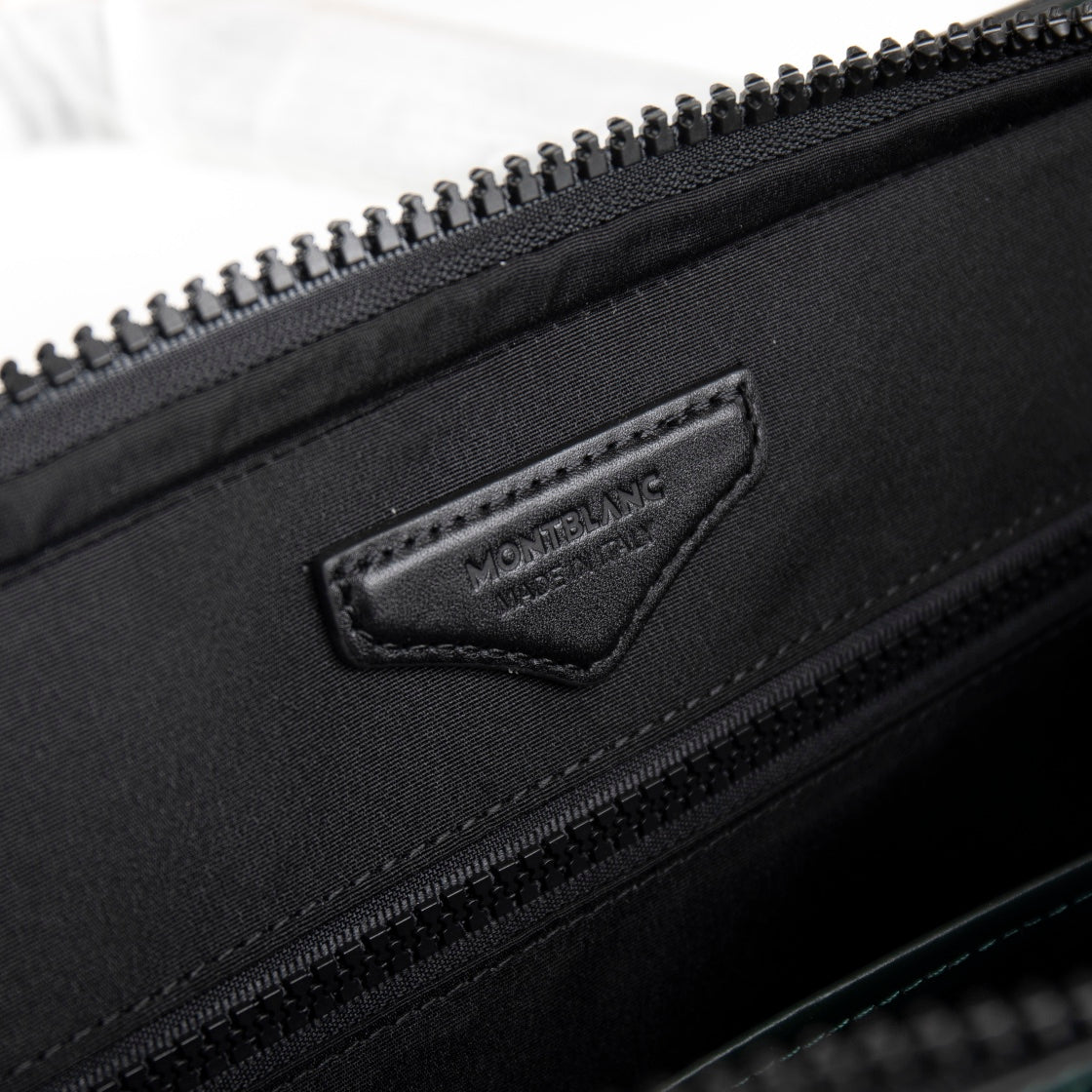 Montblanc men's dark bag exterior with logo patch and top zipper
