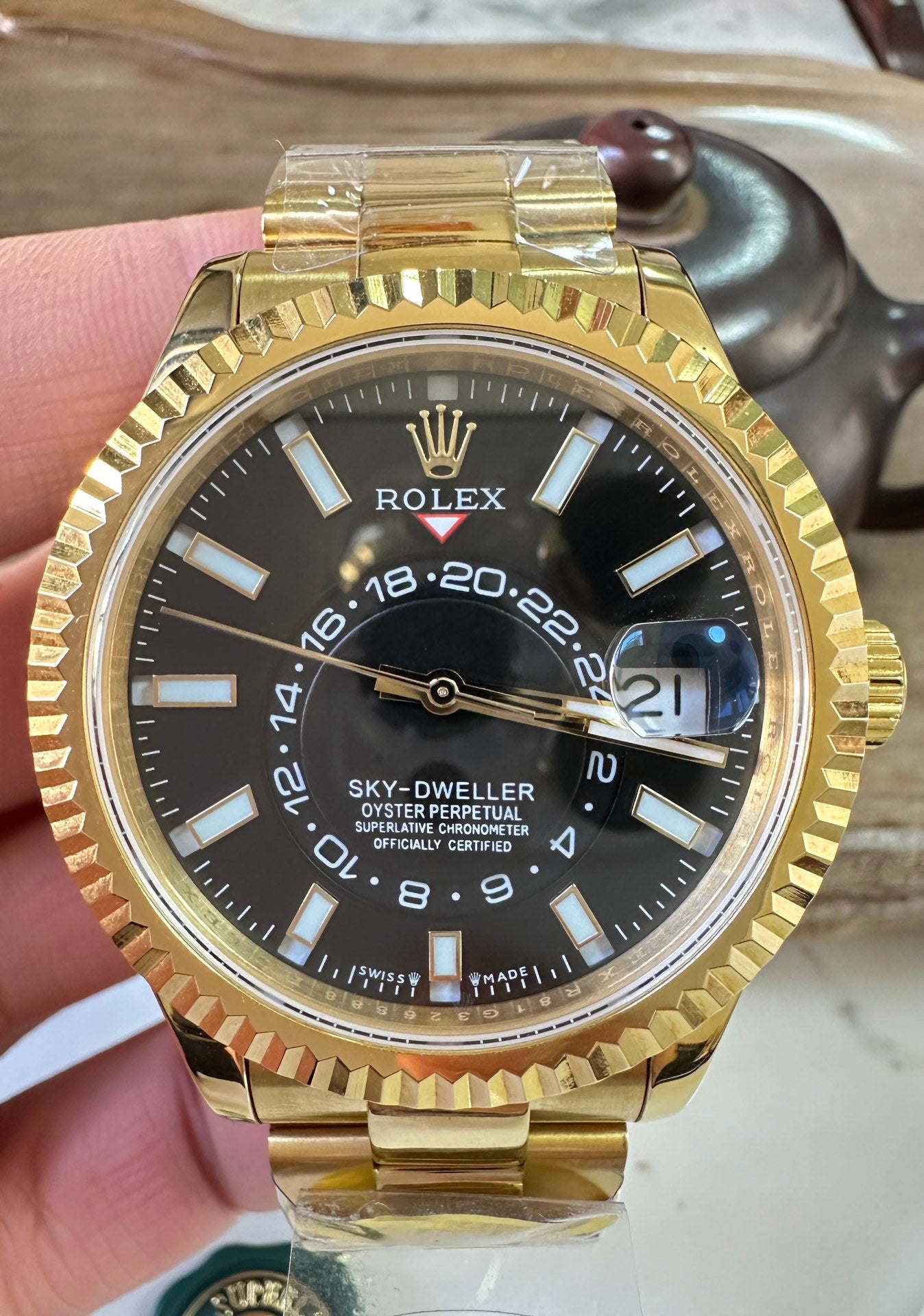 Rolex Sky-Dweller watch with black dial, gold-tone bezel and metal bracelet