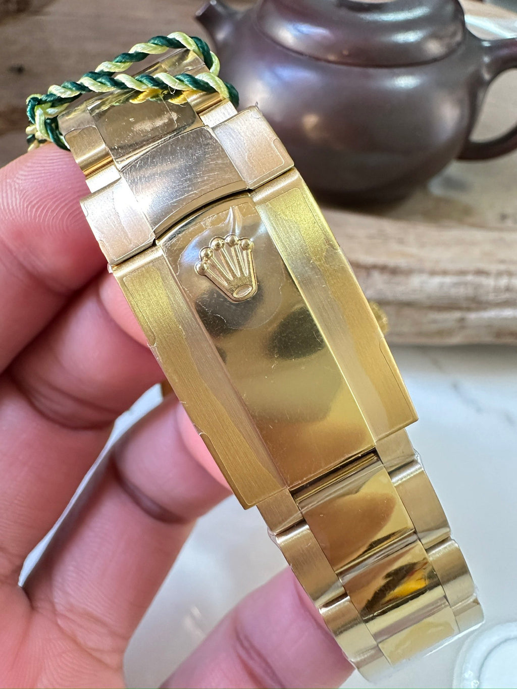Rolex Sky-Dweller watch case and gold-tone bracelet with engraved crown