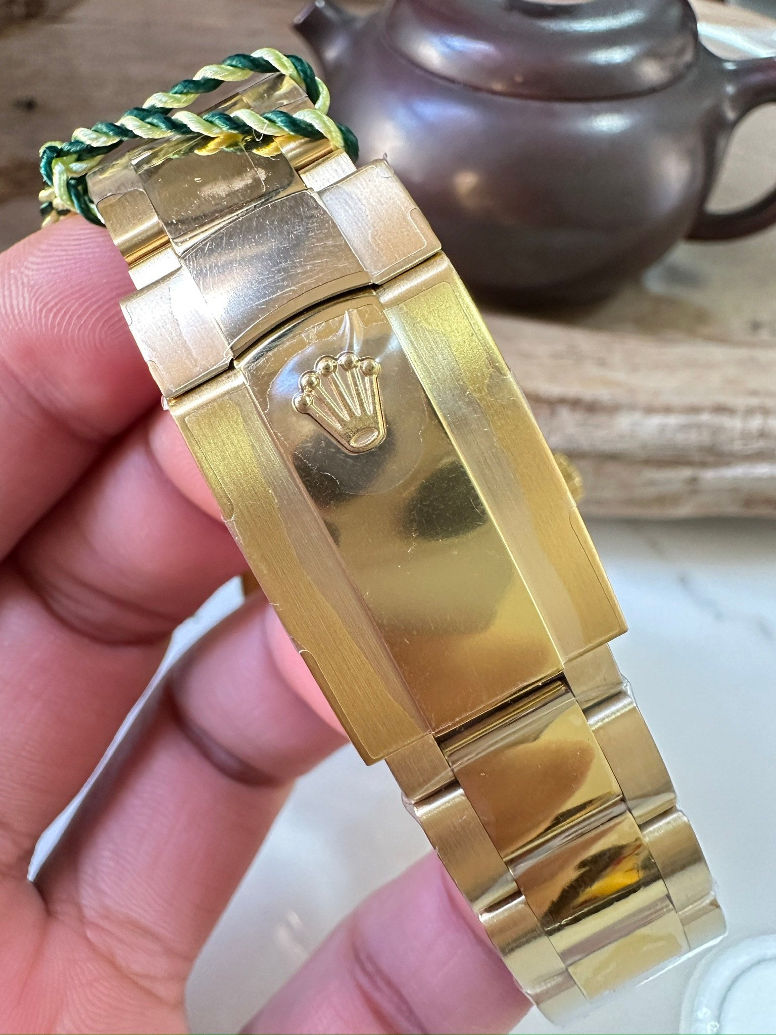 Rolex Sky-Dweller watch case and gold-tone bracelet with engraved crown