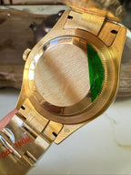 Rolex Sky-Dweller watch caseback close-up with gold-tone metal bracelet