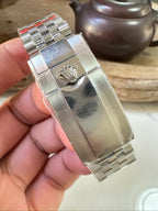 Rolex GMT watch bracelet close-up with polished metal links and deployment clasp