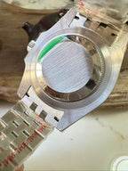 Rolex GMT watch caseback detail with circular backplate and metal bracelet links