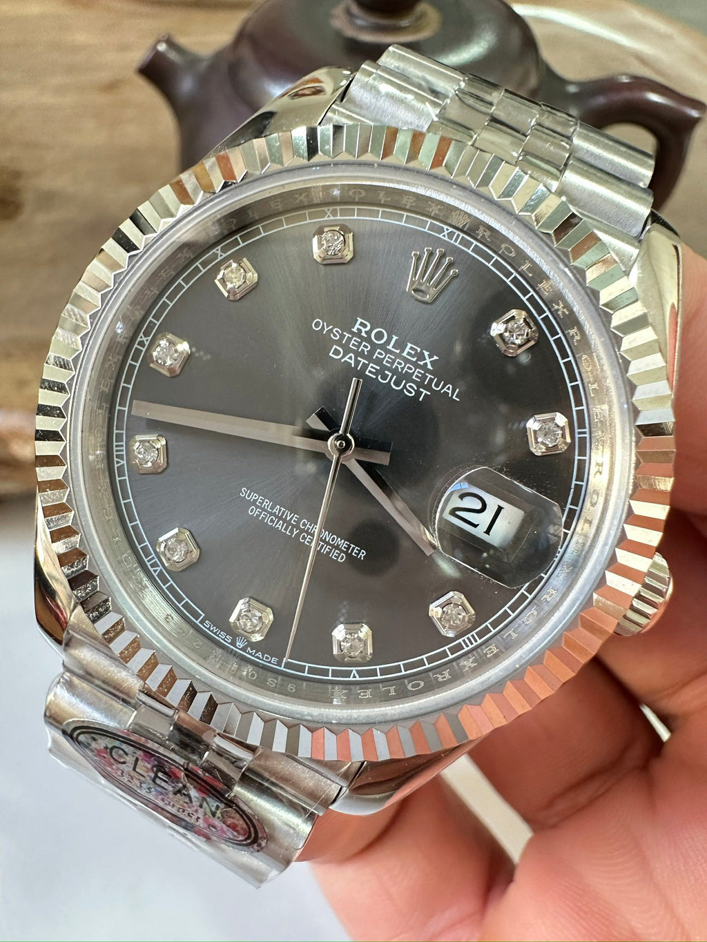 Datejust wristwatch with black dial, silver bezel, and date window 21