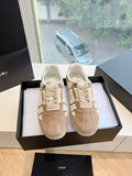 Amiri luxury sneakers, beige suede with lace-up and signature strap panel detail.