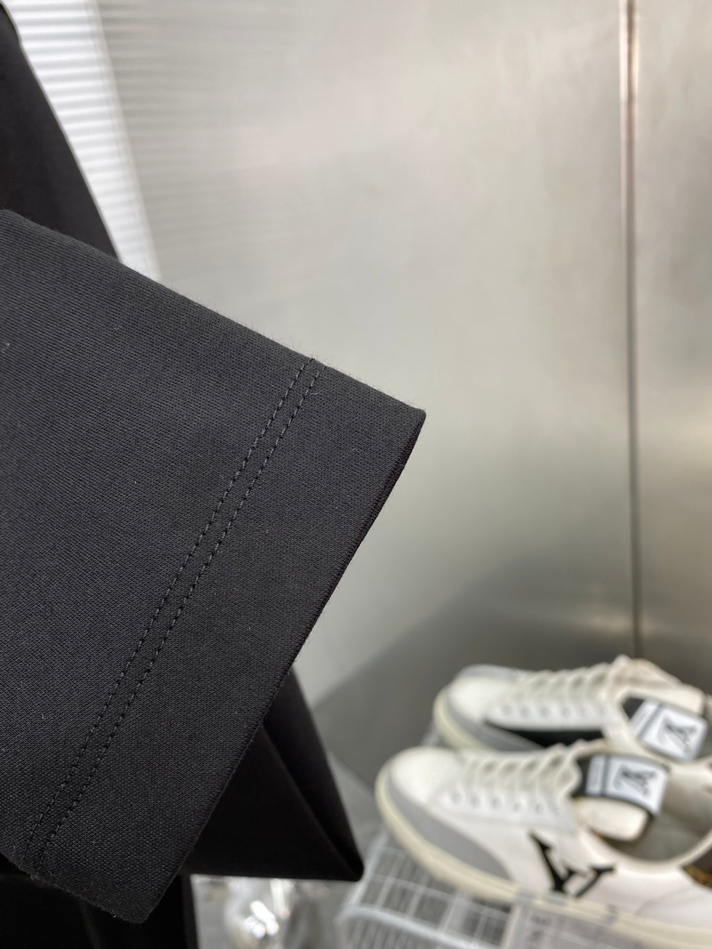 Black long-sleeve T-shirt sleeve hem detail